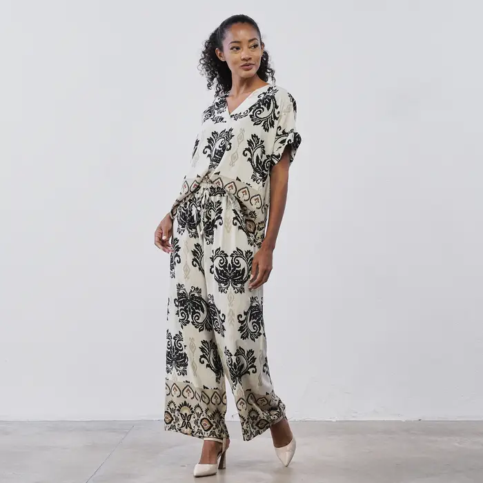 LOKITA Pantaloni lunghi palazzo da donna beige con stampa paisley nera